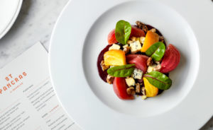 Dish of Searcys food next to a menu